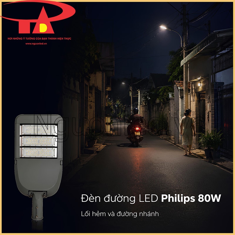 Đèn đường LED Philips 80W chiếu lối hẻm khu dân cư vào ban đêm, có xe máy và người đi bộ